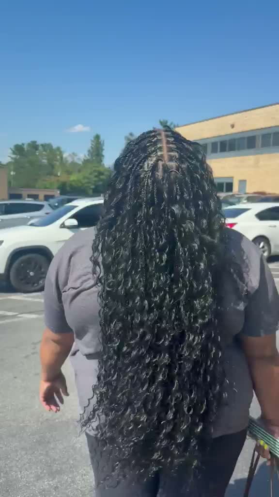Client showing off long knotless braids outdoors